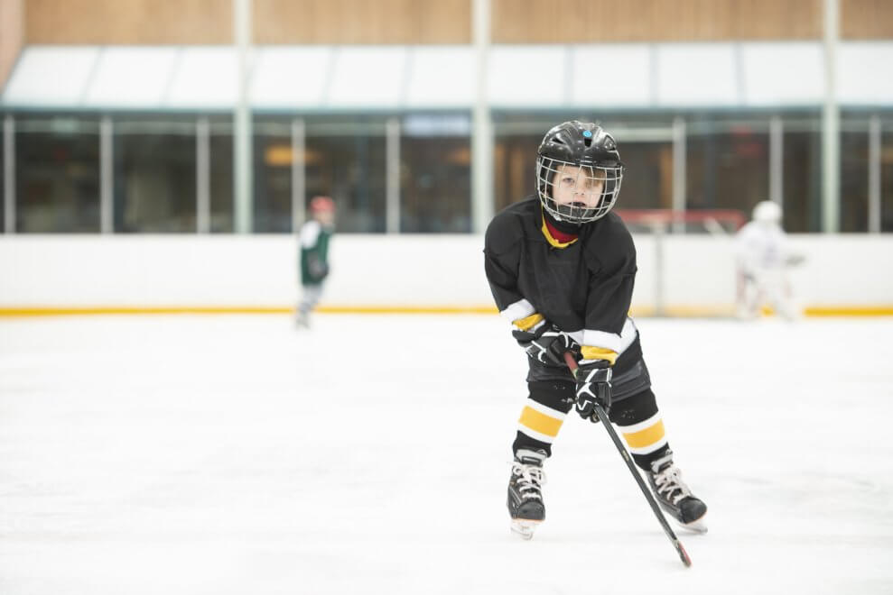 A young hockey player skates on the ice.