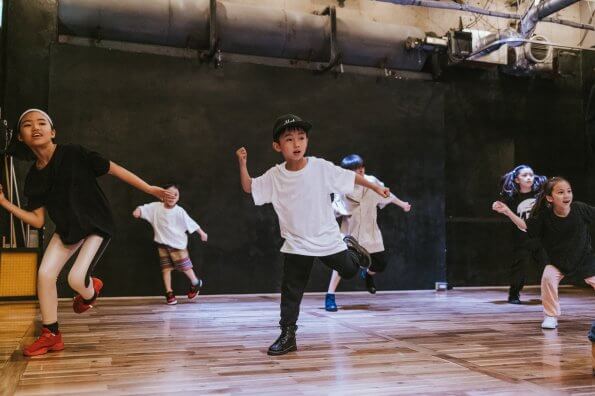 A group of kids dance on stage.