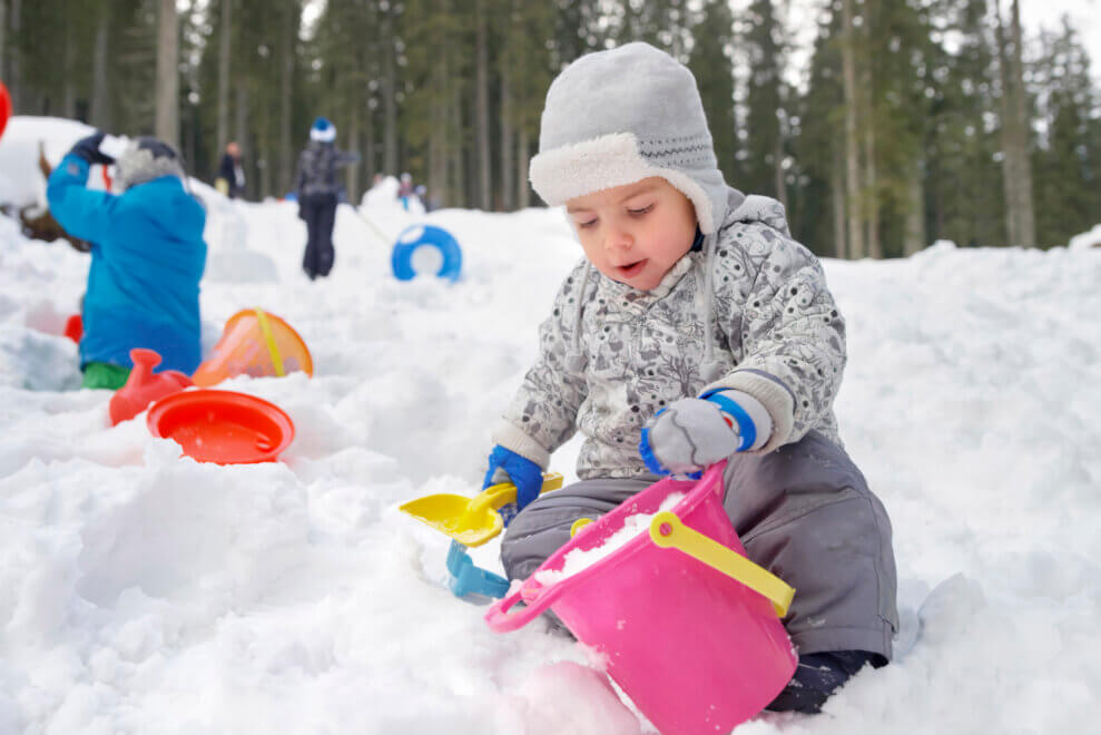 toddler-putting-snow-into-pail