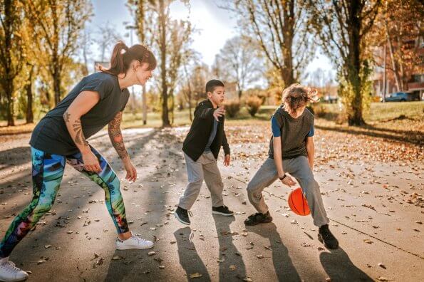 mom and boys playing basketball