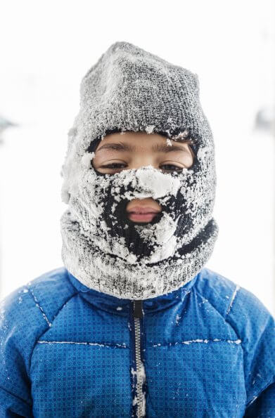 Boy wearing balaclava on snowy day