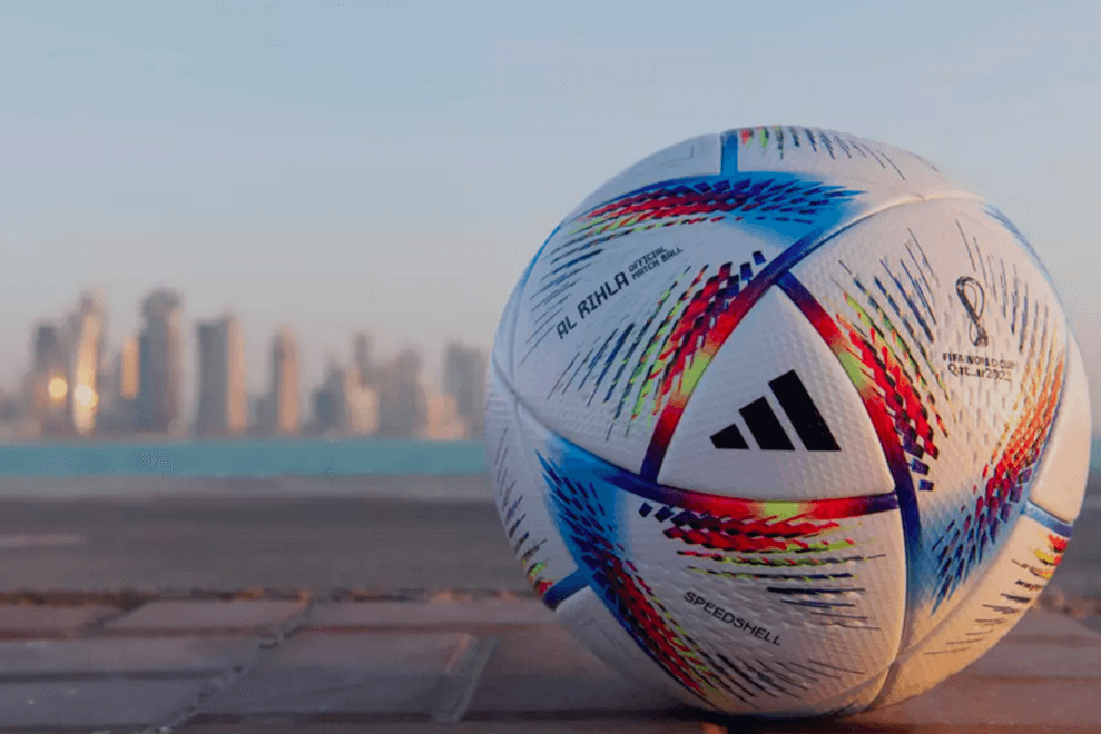 The 2022 FIFA World Cup soccer ball, designed by Adidas, sits in front the Qatar skyline.