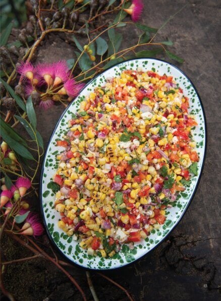 A colourful corn and veggie salad fills a platter.