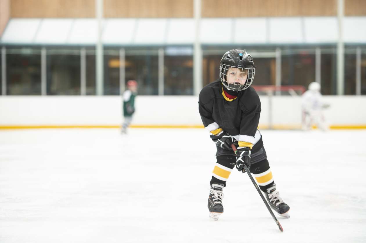 A young hockey player skates on the ice.