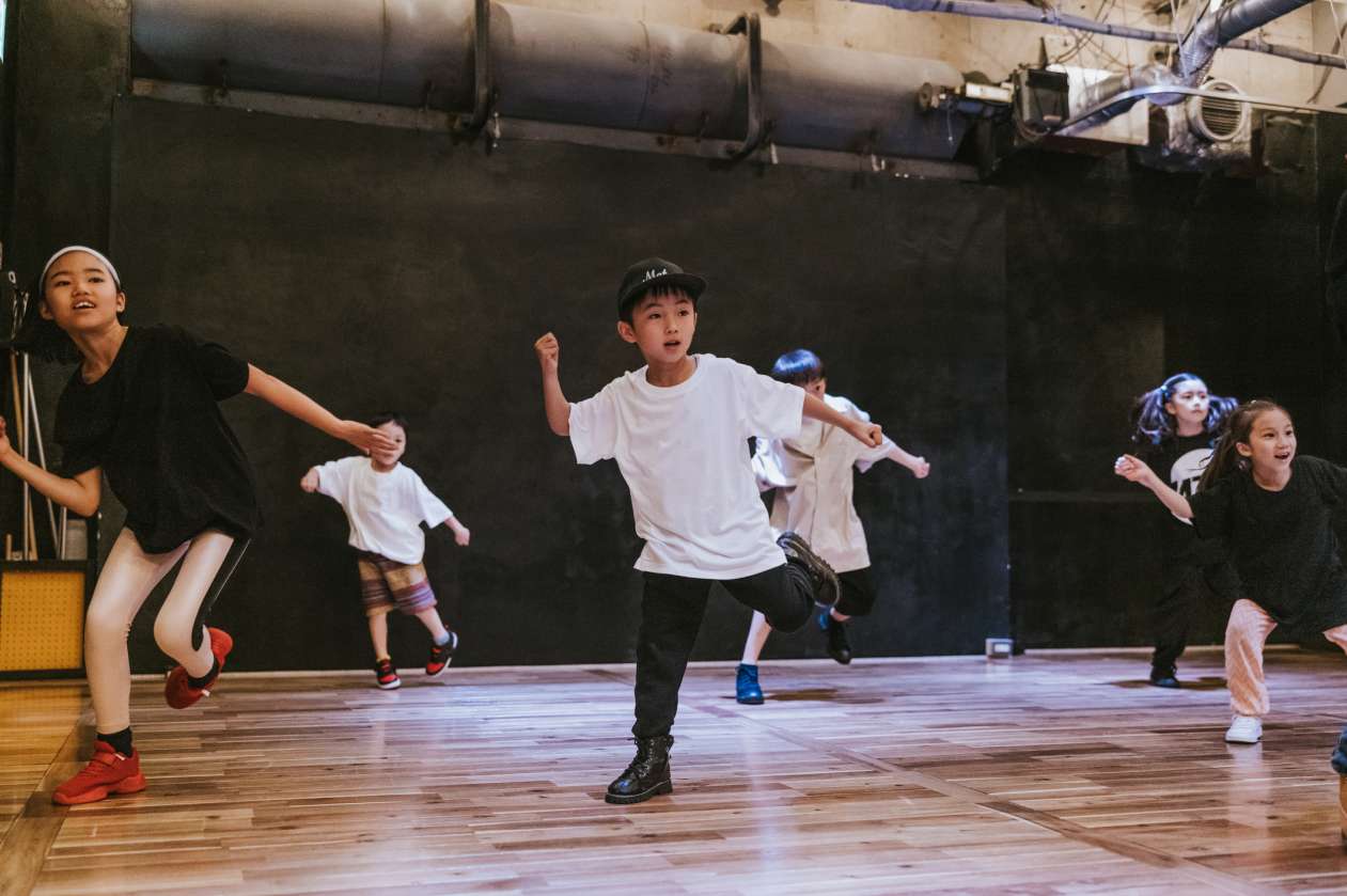 A group of kids dance on stage.