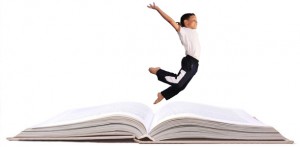 child-jumps-atop-book